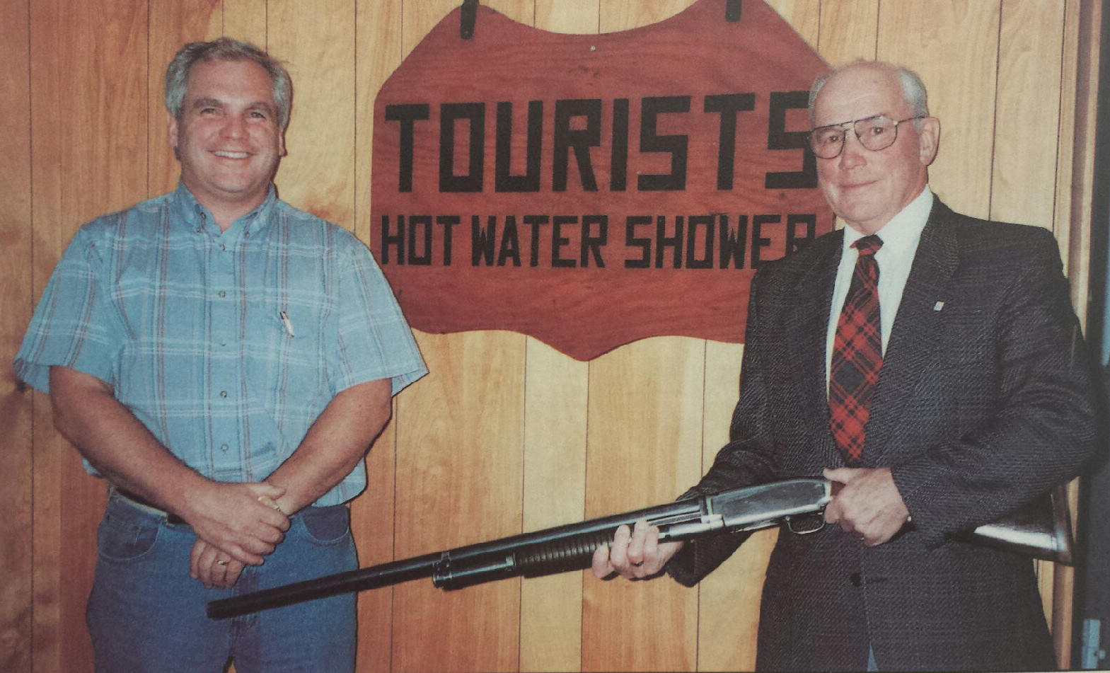 Allan (left) and Laurie holding his favourite hunting gun, received in exchange for making a leg. Tourist sign, which hung outside the family homestead, to accommodate patients due to the distance they travelled and the time required to manufacture their limbs.